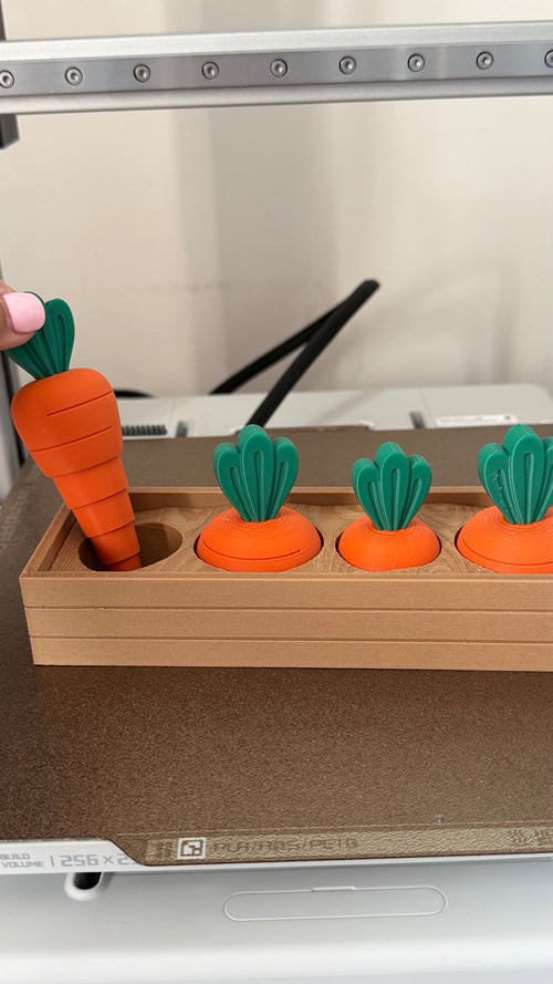 Carrot fidget lifted from its holder with its telescopic sections extended