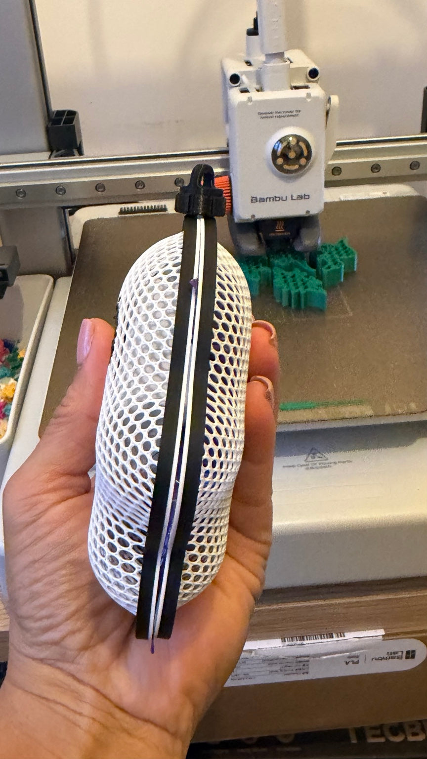 Side view of a ghost-shaped mesh treat holder with black frame