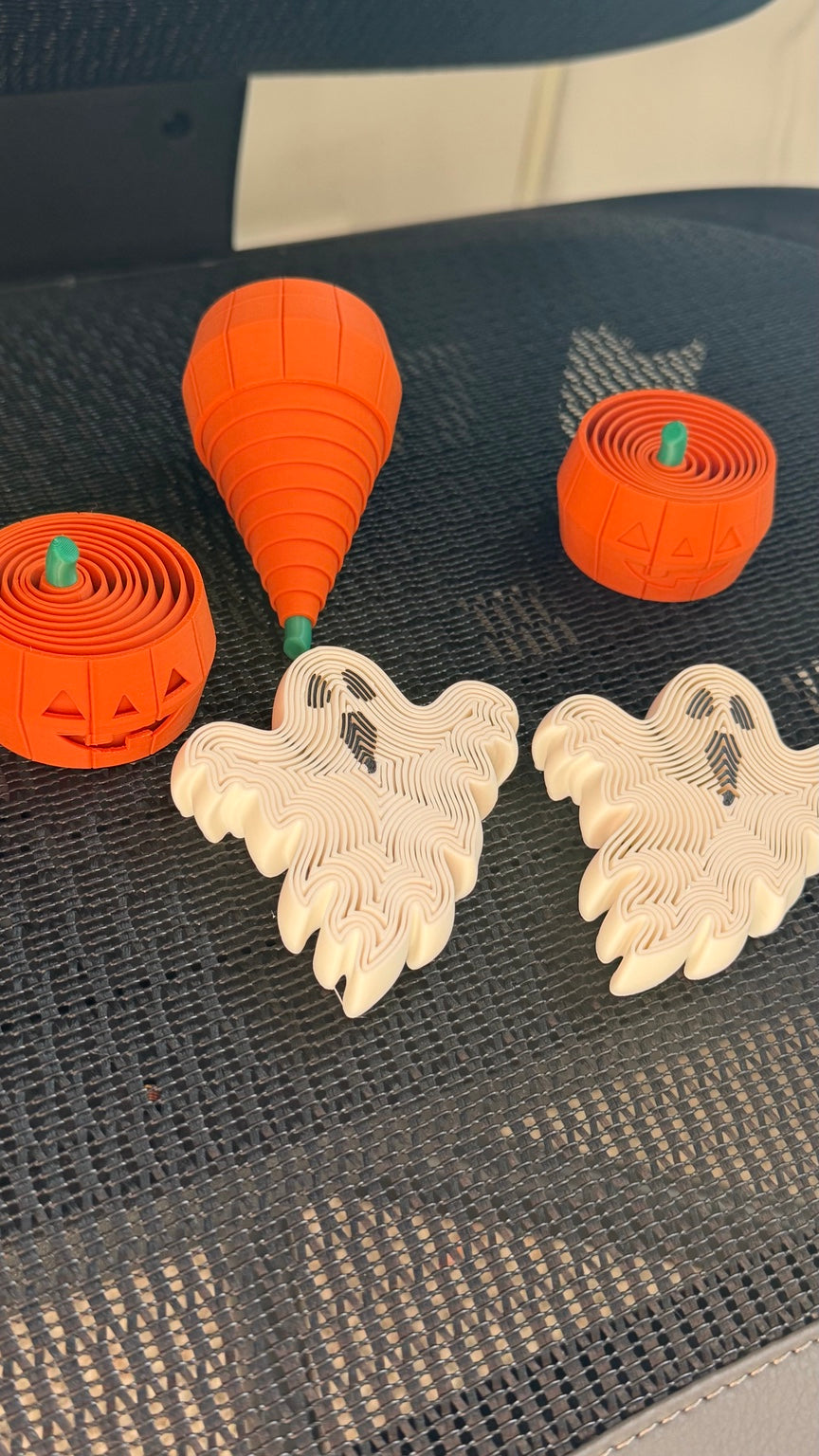 Pumpkin and ghost fidgets with an orange pumpkin extended into a cone shape